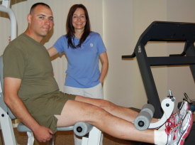 Physical therapy assistant Kevin Callahan, PTA, left, treats the ankle of Brian Edwards 